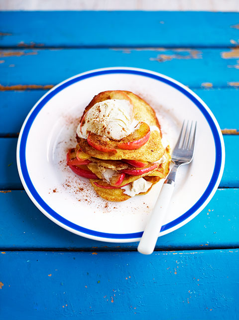 A Picture of a Lady Eating a Lot of Pancakes Kid