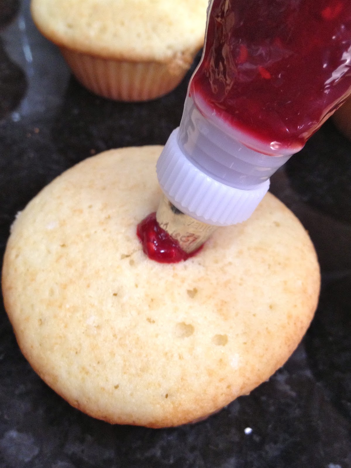 White Cupcakes with Raspberry Filling