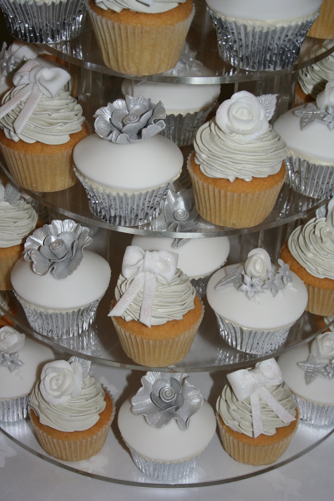 White and Silver Wedding Cake with Cupcakes