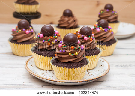 Cupcakes with Frosting and Chocolate Balls Gold Cupcakes with Frosting and Chocolate Balls Gold
