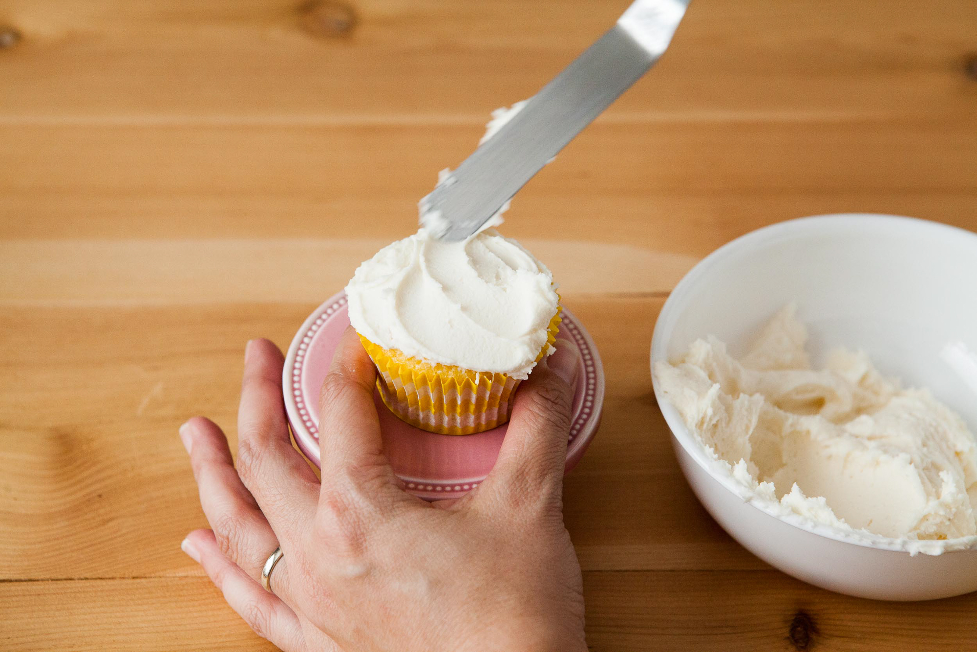 Woman Frosting Cupcakes